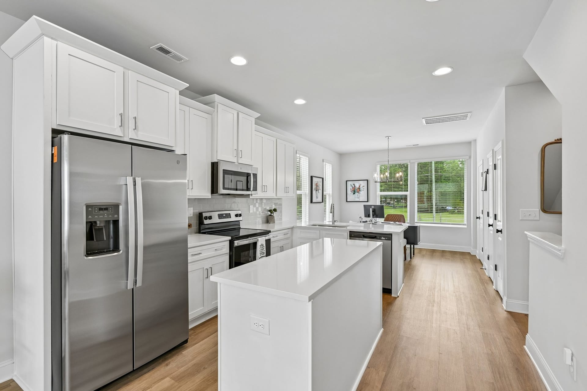 Crossings at NoDa: kitchen with white cabinets and an island