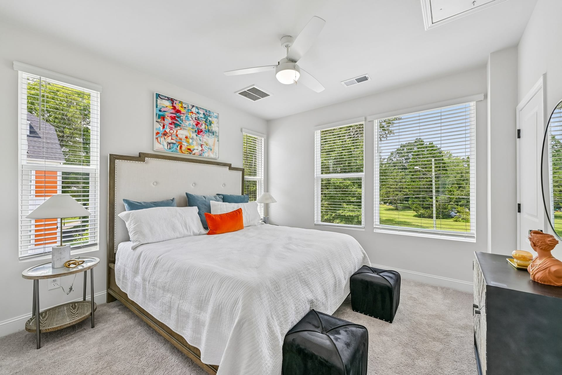 Crossings at NoDa: bedroom with a tufted headboard and two windows