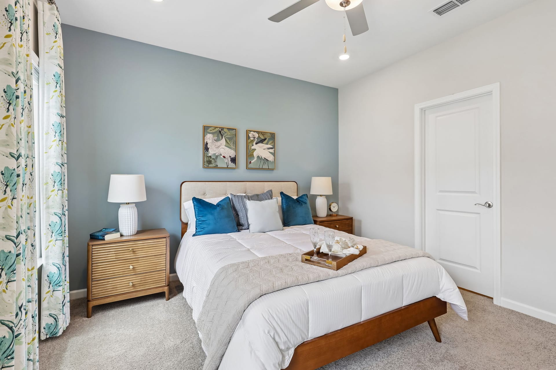 Harts Branch Townhomes: bedroom with blue walls and a ceiling fan