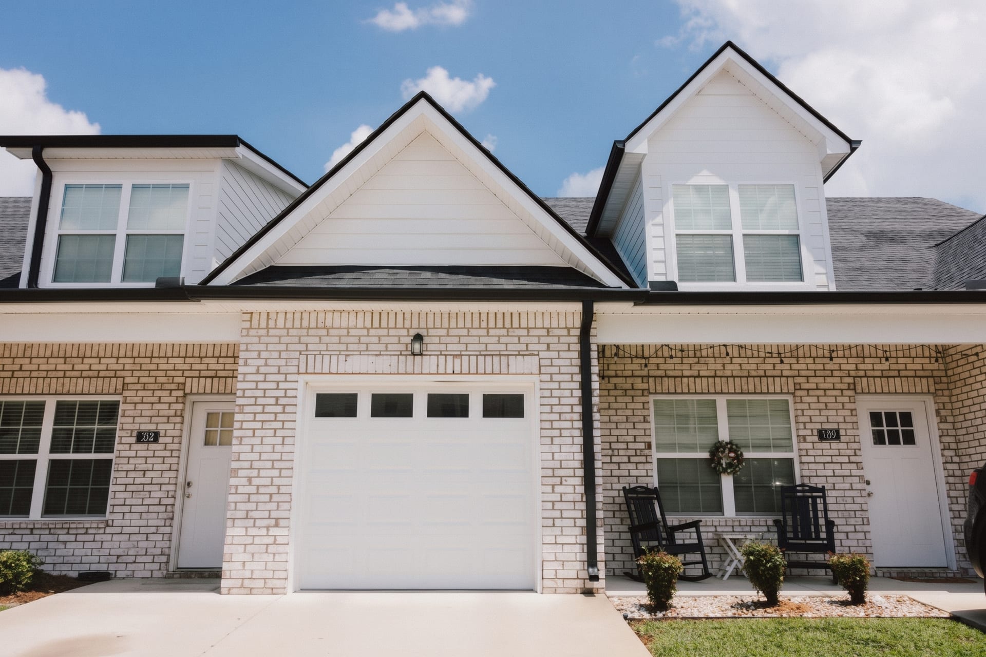 South Maple Townhomes, Lebanon, Tennessee: brick townhome fronts with a garage, covered porches and rocking chairs