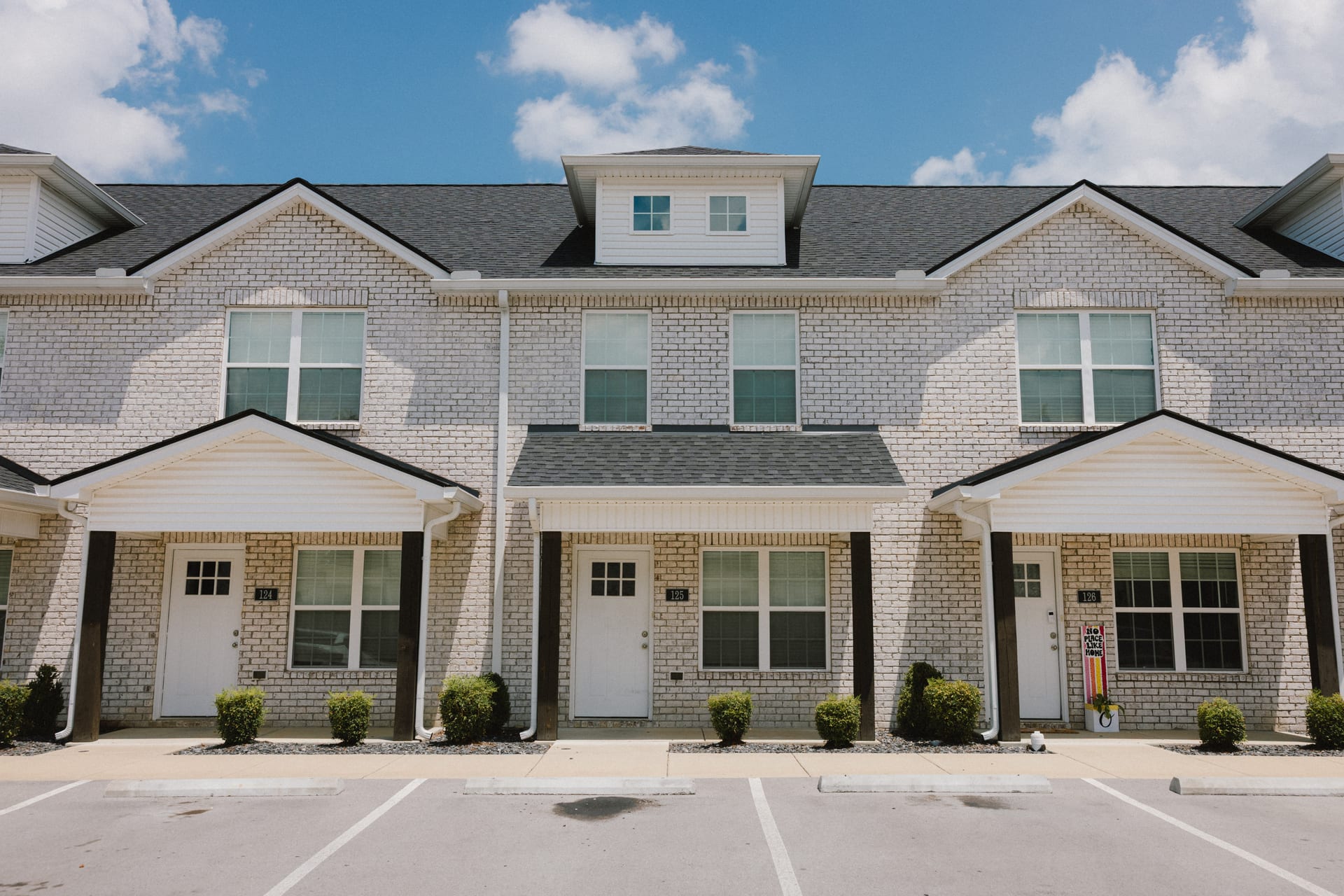 South Maple Townhomes, Lebanon, Tennessee: brick townhome fronts with covered entries and parking