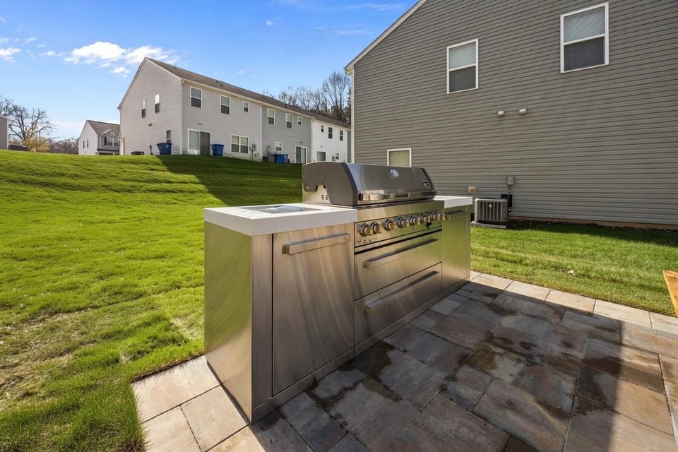 The Grove Residences: outdoor grill station on a paved patio
