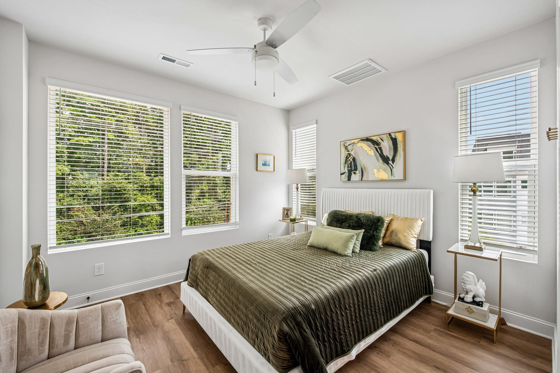 Towns at Eastland: bedroom with a green quilt and large windows