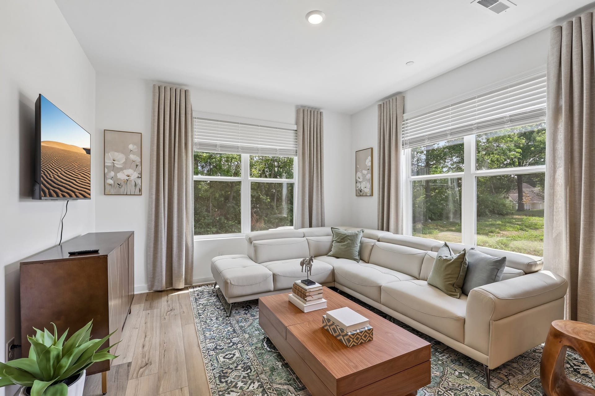 Vinewood Townhomes: living room with a sectional sofa and tall windows